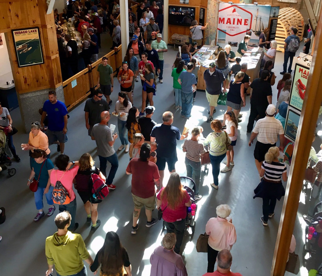 People gathered in an exhibition hall to learn about Maine agricultural