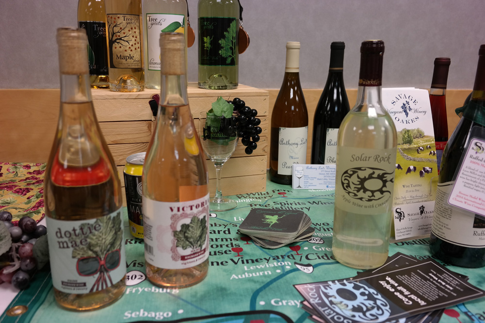 Display table with many bottles of local Maine wine