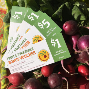 SNAP bonus vouchers on a group of radishes