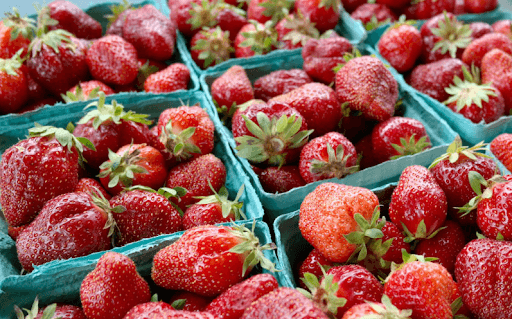Ripe strawberries in blue containers